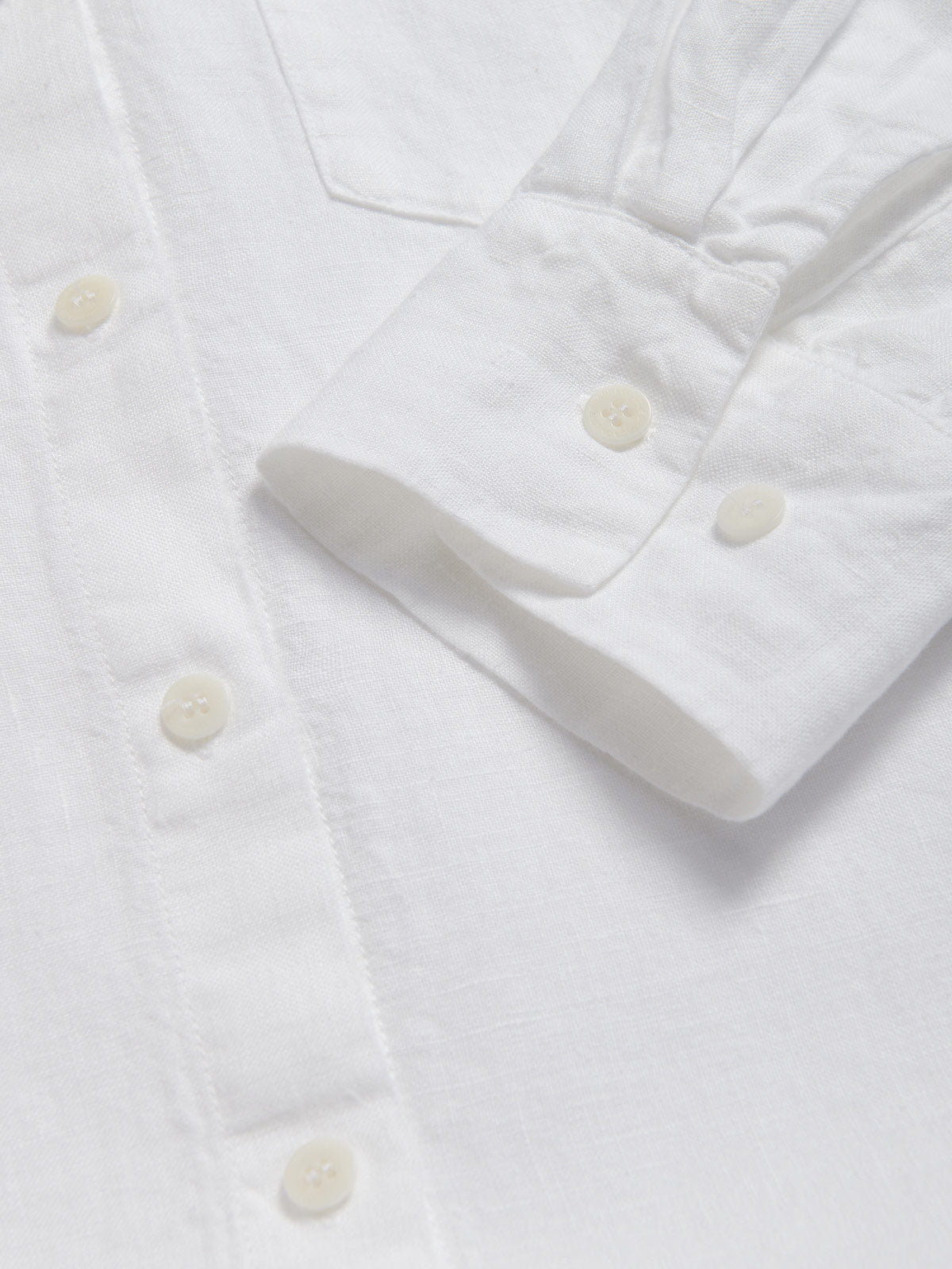 Cuff view of Womens White Sapodilla Linen Shirt Dress. Long sleeve, button-up midaxi dress with front pocket made from 100% linen.