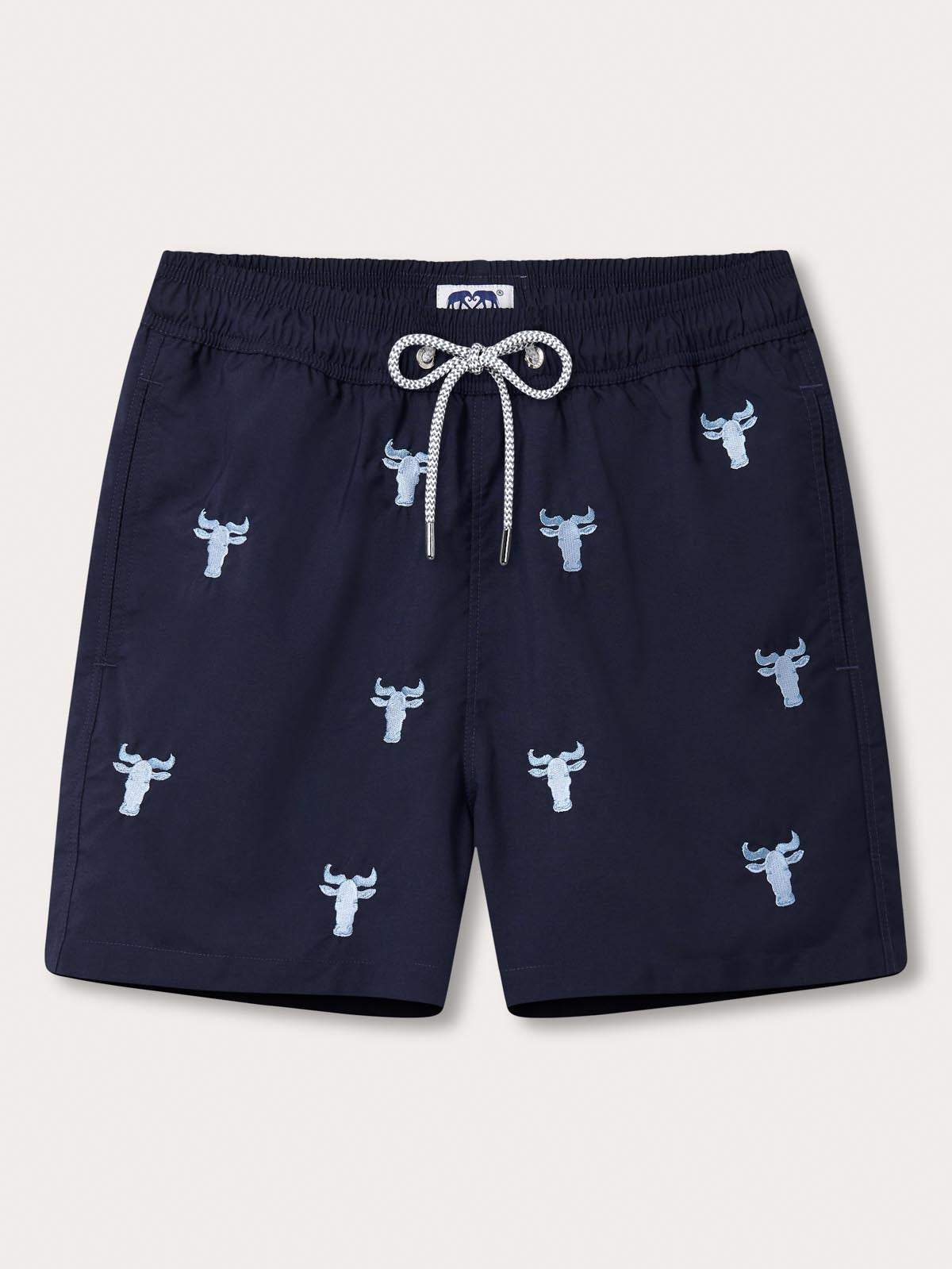 Men's Mara Crossing Embroidered Staniel Swim Shorts in navy, featuring Sky Blue embroidered wildebeest motifs. Patterned swim shorts with a drawstring waistband.