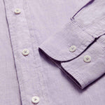 Close-up view of Men's Lilac Abaco Linen Shirt cuff. Pastel purple long-sleeved, button-up 100% linen shirt.