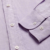 Close-up view of Men's Lilac Abaco Linen Shirt cuff. Pastel purple long-sleeved, button-up 100% linen shirt.