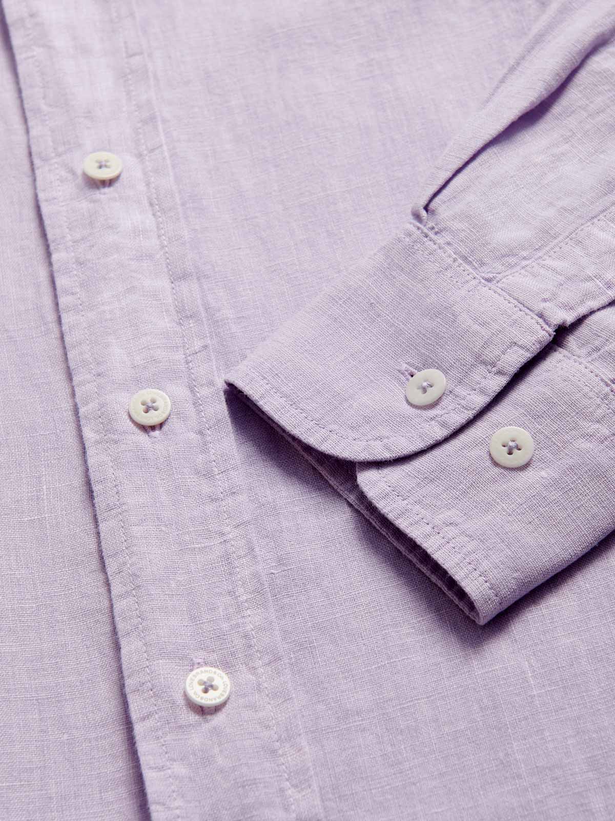 Close-up view of Men's Lilac Abaco Linen Shirt cuff. Pastel purple long-sleeved, button-up 100% linen shirt.