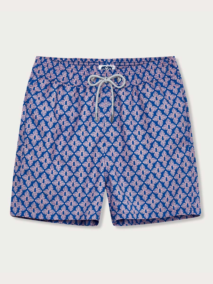 Men's Palm Paradise Staniel Swim Shorts featuring pastel pink Monstera leaf print on blue background.