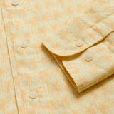 View of cuffs of Men's Palm Sundowner Abaco Linen Shirt by love brand & co. Yellow and orange patterned shirt with classic collar and long-sleeves. Button-up design made from 100% linen.