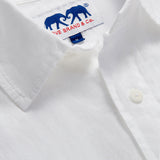 Close-up of the collar of Men's White Andros Linen Shirt. Long-sleeved, button-up white linen shirt. Double-breasted with a classic collar.