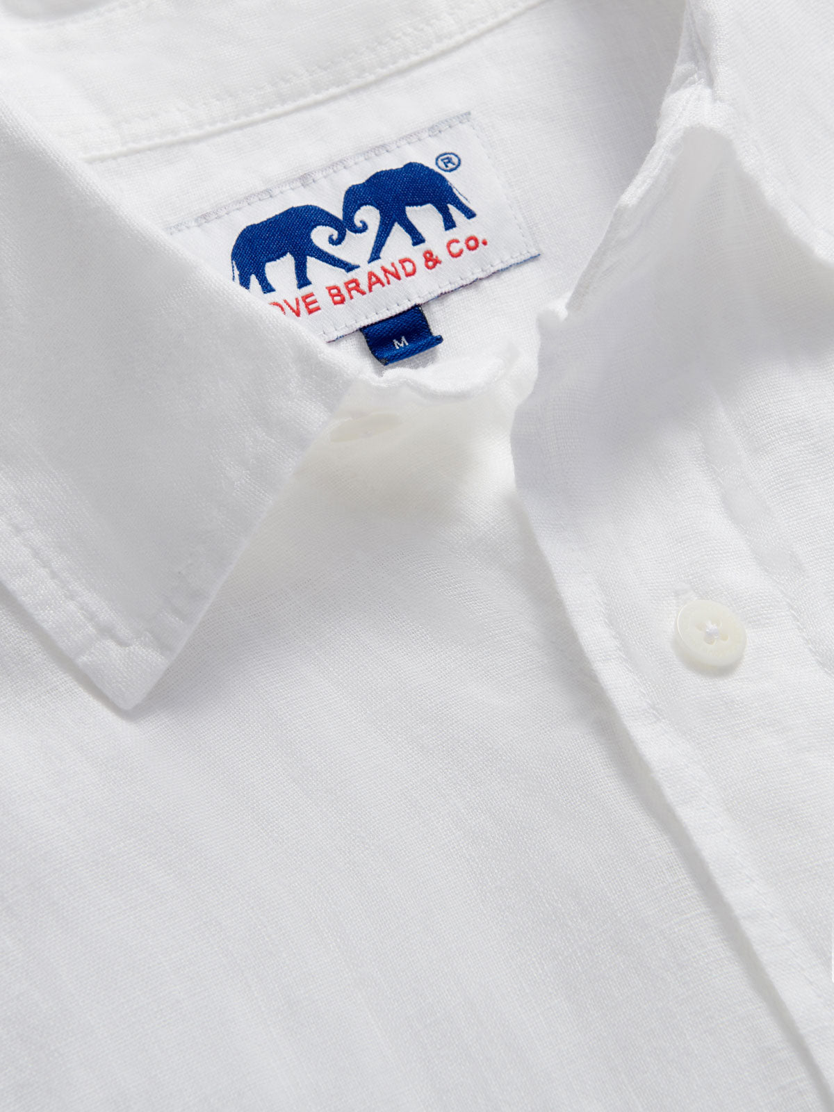 Close-up of the collar of Men's White Andros Linen Shirt. Long-sleeved, button-up white linen shirt. Double-breasted with a classic collar.