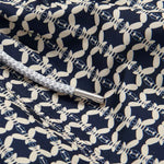 Close-up of the fabric detail on Men's Bee Propelled Staniel Swim Shorts with white bee patterns on a navy background and a grey drawstring.