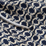 Close-up view of Men's Bee Propelled Staniel Swim Shorts featuring a deep blue base with a unique stone-coloured bee print, showcasing intricate details and a braided drawstring with branded metallic tip.
