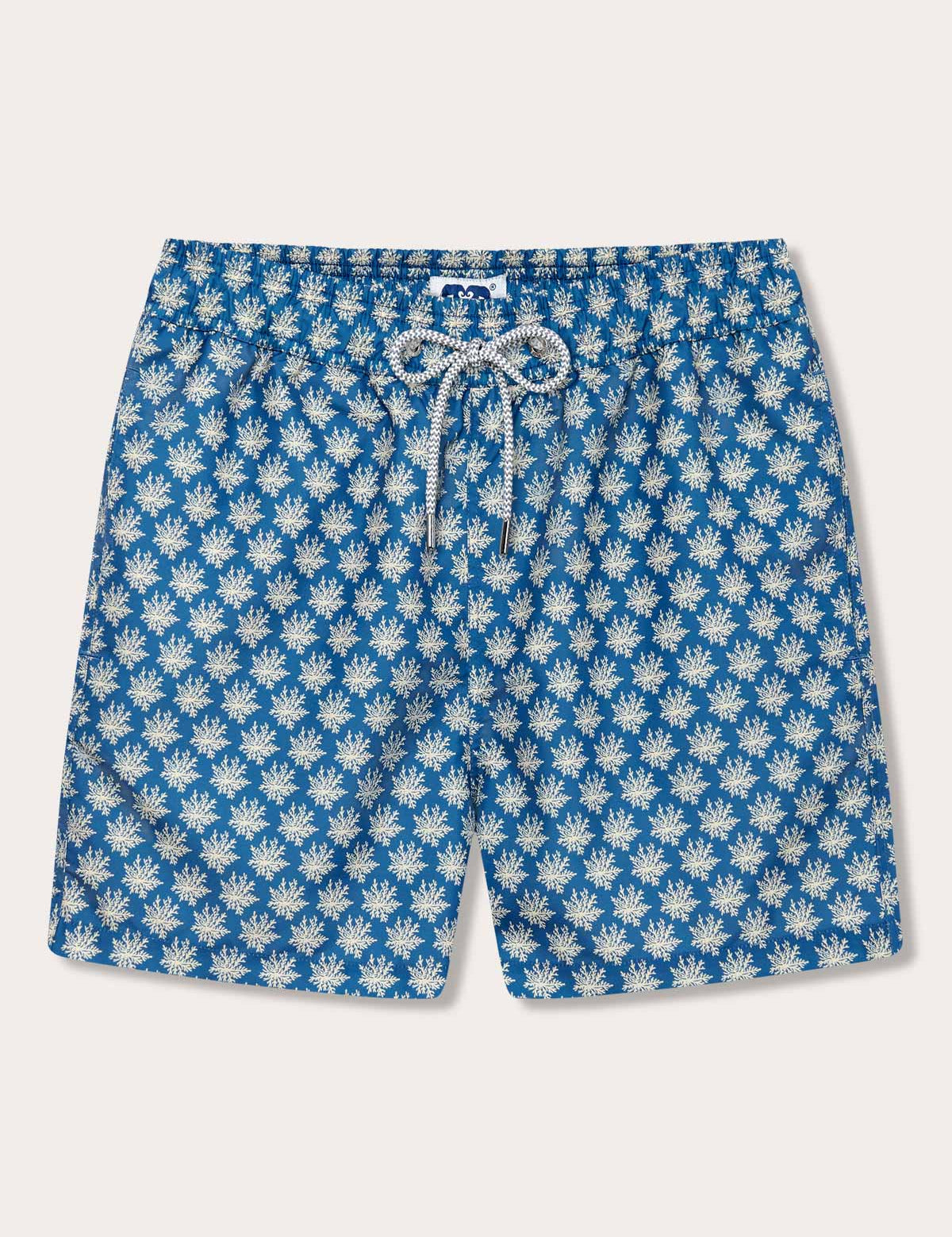 Men's Coral Clusters Staniel Swim Shorts featuring a luxurious stone-shaded coral design. Patterned swim shorts on a blue background crafted from 100% recycled materials with a drawstring closure.