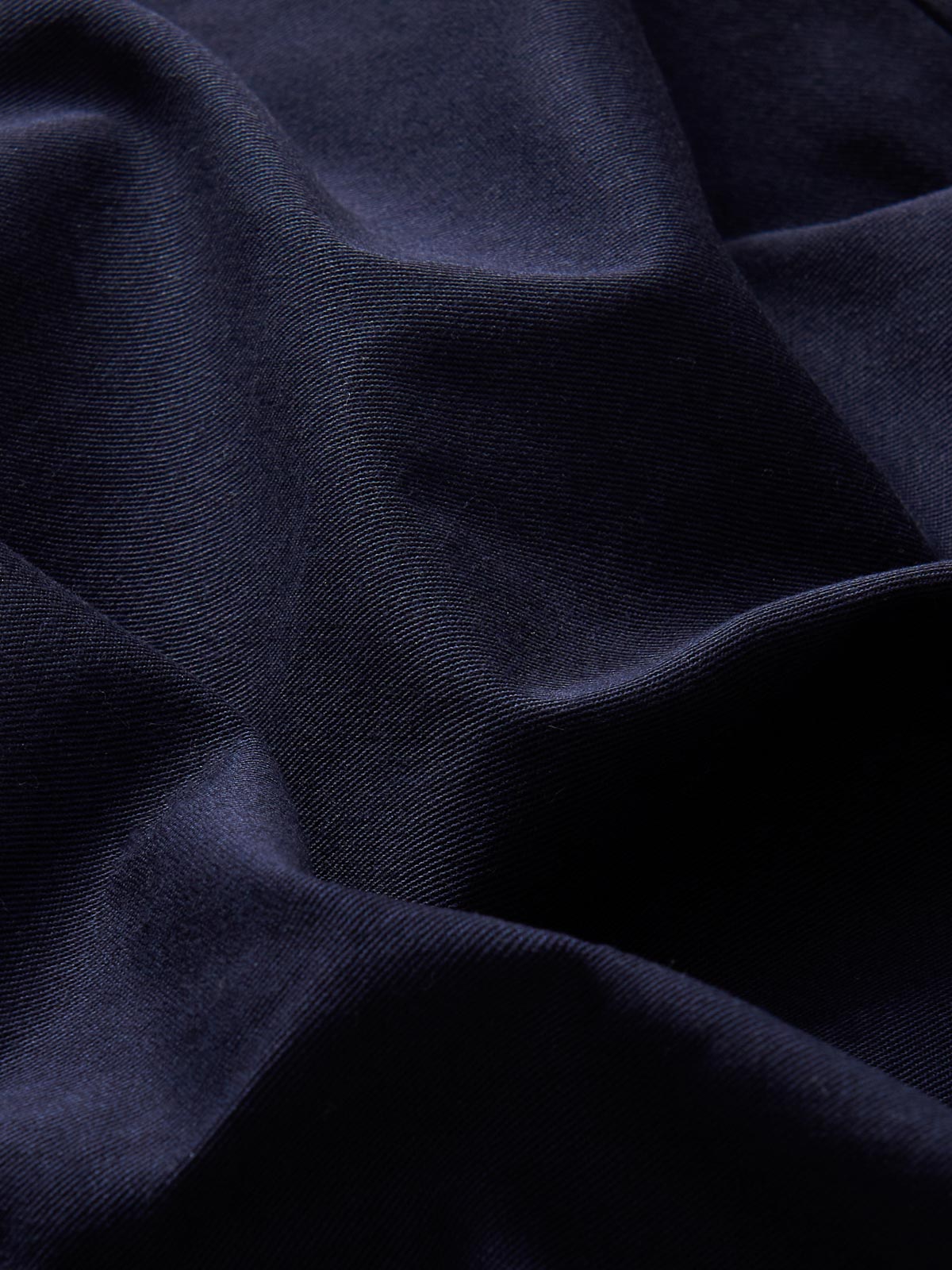 Detailed view of men's cotton chinos navy blue fabric