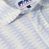 Close-up of Men's Dishy Fishy Abaco Linen Shirt featuring a chic print of a school of fish in serene blue and white hues.