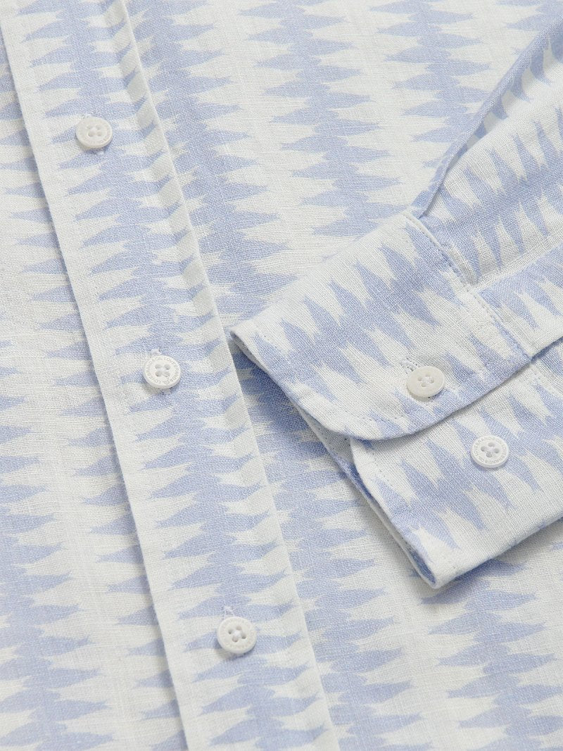 Close-up of Dishy Fishy Abaco men's Linen Shirt, featuring a serene blue and white fish pattern with white buttons, crafted from breathable 100% linen.