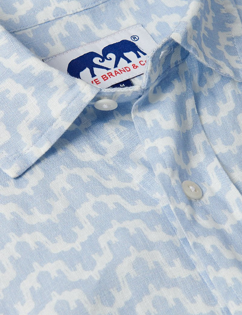 Close-up of Men's Elephant Palace Sky Abaco Linen Shirt featuring a blue and white patterned elephant and palace print.