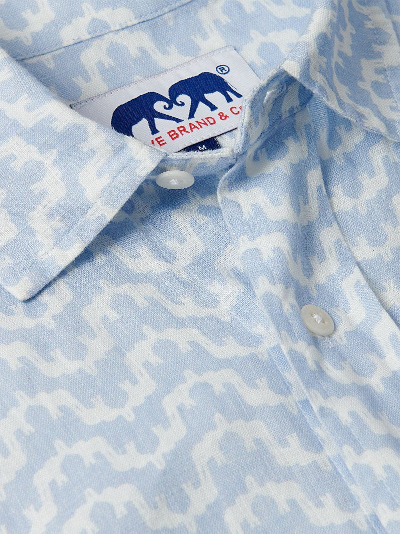 Close-up of Men's Elephant Palace Sky Abaco Linen Shirt featuring a blue and white patterned elephant and palace print.