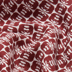 Close-up view of men's Joulter Linen Shorts featuring a pattern of dark burgundy elephants on a white background.