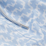 Close-up of Men's Elephant Palace Sky Staniel Swim Shorts, featuring a light blue background with white elephant and palace pattern, detailed with a braided drawstring.