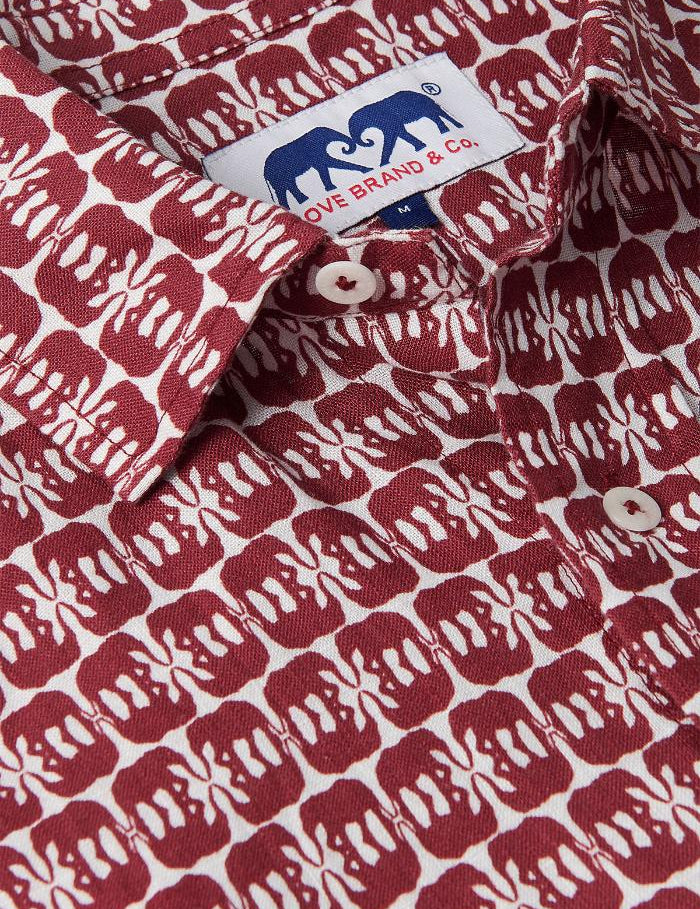 Close-up of Men's Elephants of India Abaco Linen Shirt showcasing dark burgundy elephants pattern on a white background with visible brand label. Old money shirts crafted from 100% linen.