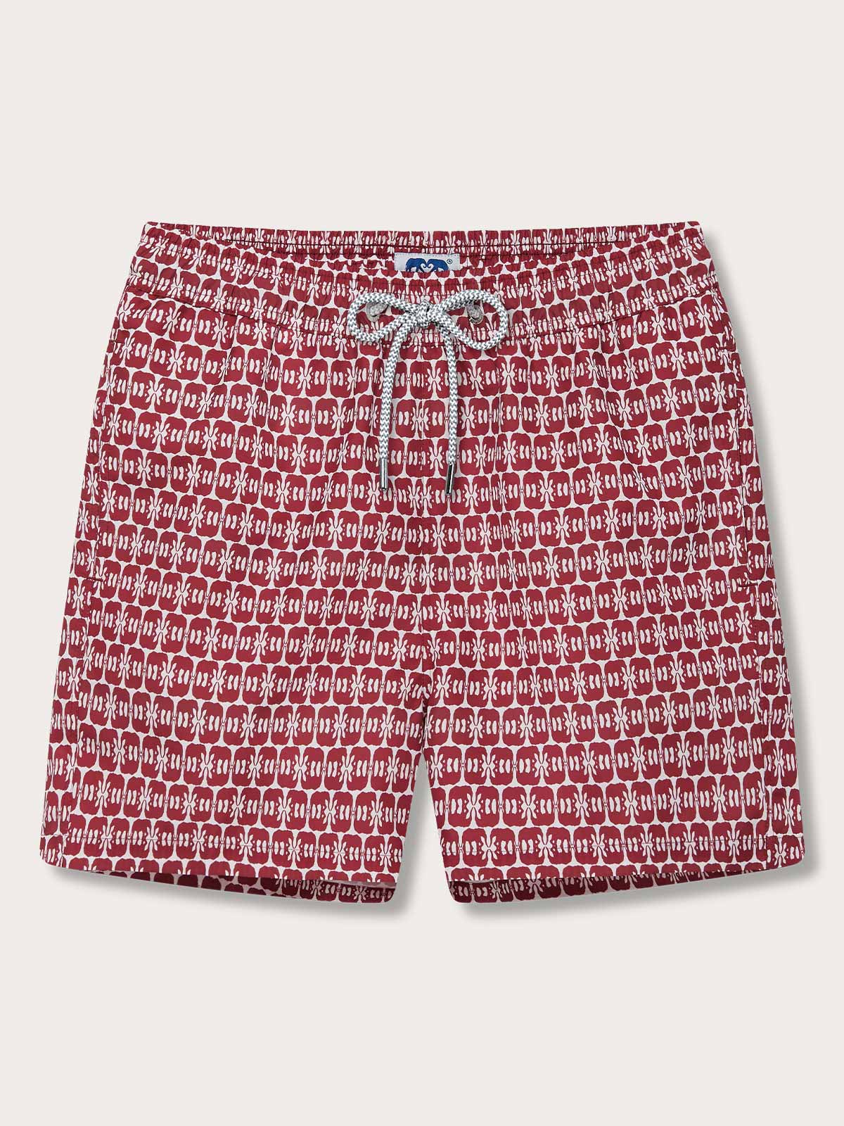 Men's Elephants of India Staniel Swim Shorts featuring dark burgundy elephants on a white background. Patterned swim shorts made from 100% recycled quick-drying fabric, displayed on a flat surface.