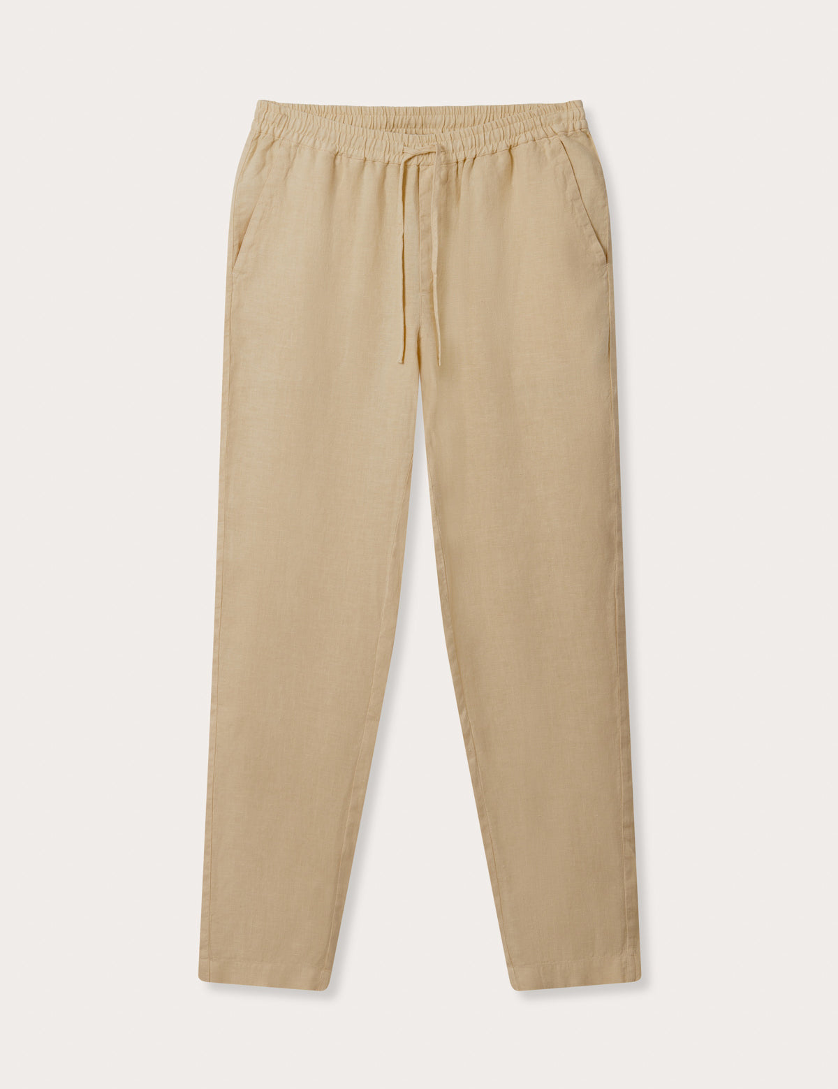 Front view of Men's Coconut Eleuthera Linen Trousers. Beige linen pants for men with 2 front pockets, drawstring tie and elastic waist.