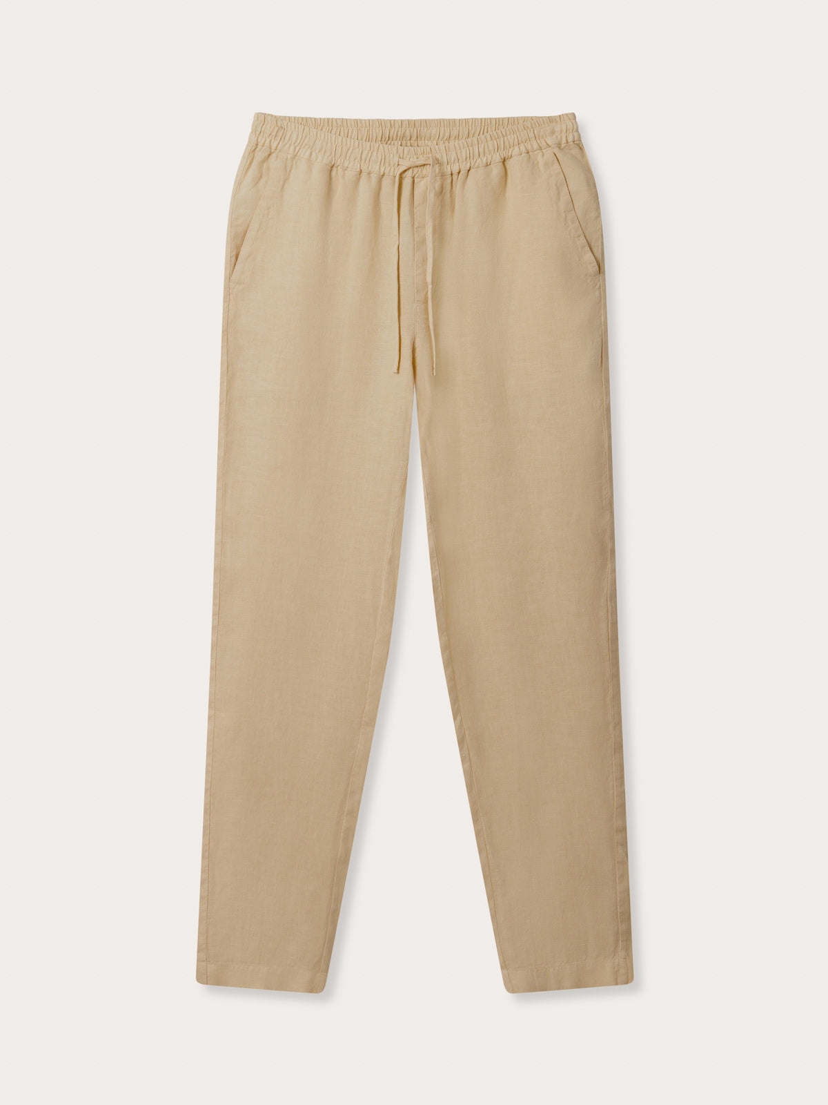 Front view of Men's Coconut Eleuthera Linen Trousers. Beige linen pants for men with 2 front pockets, drawstring tie and elastic waist.