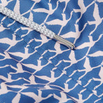 Close-up image of the Men's Flamingo Flamboyance Staniel Swim Shorts. Patterned swim shorts featuring a blue and white flamingo print pattern, highlighting the intricate stitching and a cord detail.