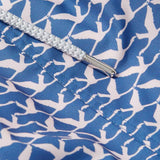 Close-up image of the Men's Flamingo Flamboyance Staniel Swim Shorts. Patterned swim shorts featuring a blue and white flamingo print pattern, highlighting the intricate stitching and a cord detail.