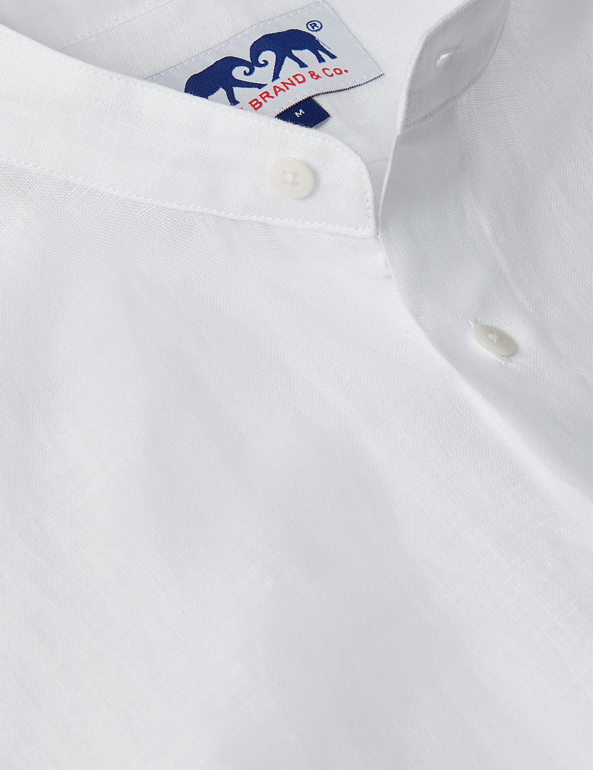 Men's White Go With The Flow Maycock Linen Shirt, featuring a close-up view of the breathable, lightweight linen fabric and a neatly stitched button.