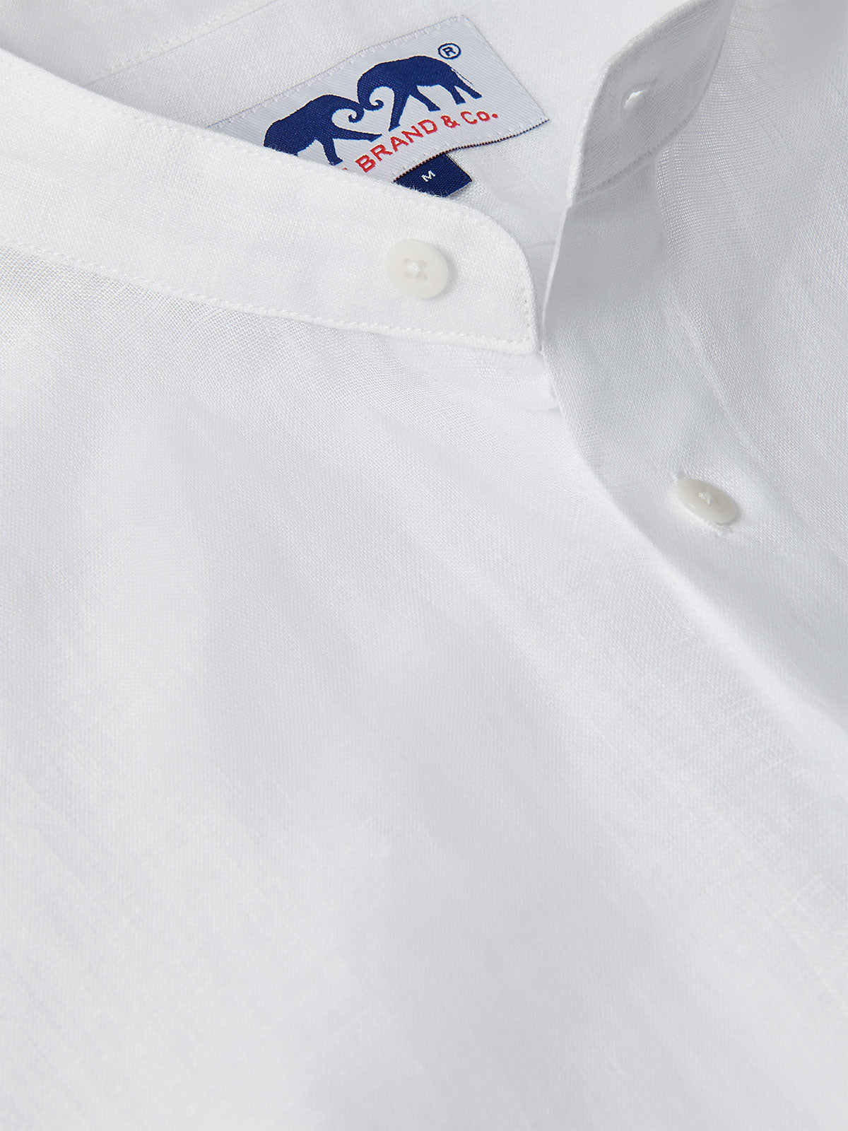 Men's White Go With The Flow Maycock Linen Shirt, featuring a close-up view of the breathable, lightweight linen fabric and a neatly stitched button.