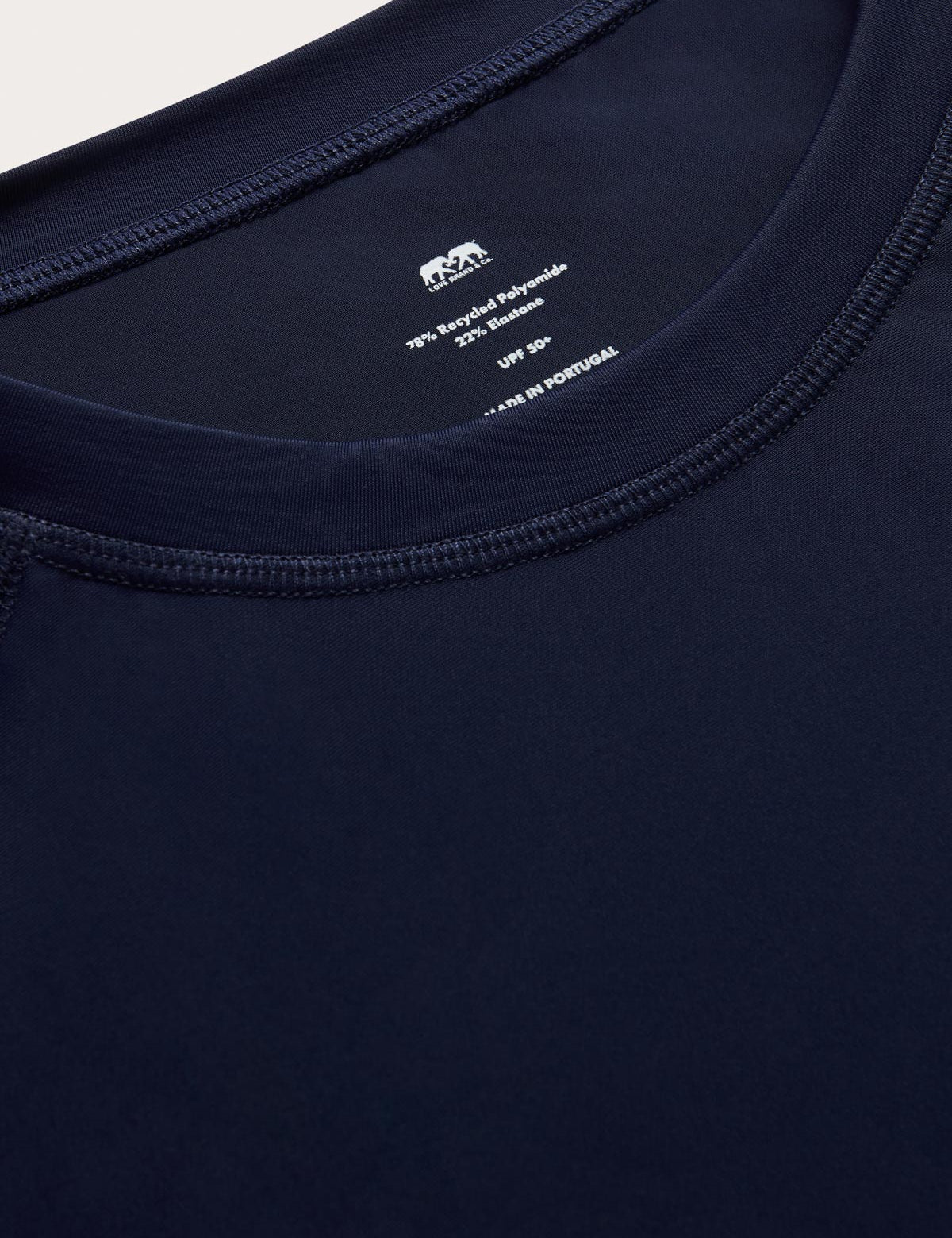 Close-up of mens navy blue rash vest with classic rounded collar and long sleeves.