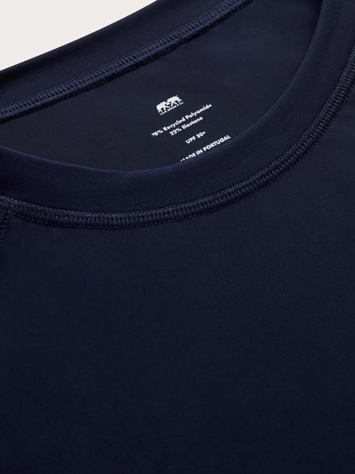 Close-up of mens navy blue rash vest with classic rounded collar and long sleeves.