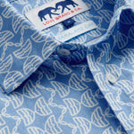 Close-up view of Men's Kissing Fish Abaco Linen Shirt. 100% linen shirt showcasing white kissing fish pattern on a blue base.