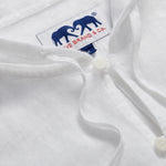 Close-up of Men's White Windermere Linen Long Sleeve Hoodie. Long-sleeved half-button-up 100% linen hoodie. 2 front pockets with a drawstring hood.