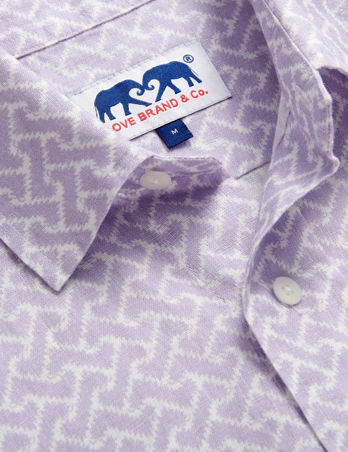 Close-up view of Men's Crazy Maze Abaco Linen Shirt. Long-sleeved, button-up white and purple patterned linen shirt. 