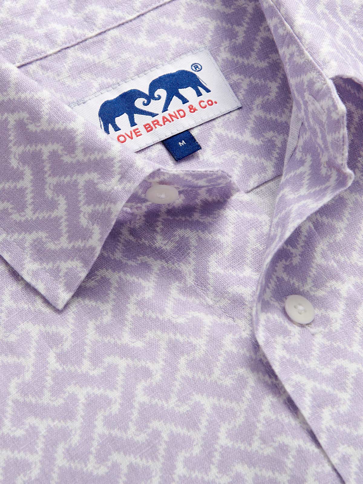 Close-up view of Men's Crazy Maze Abaco Linen Shirt. Long-sleeved, button-up white and purple patterned linen shirt. 