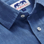 Detailed view of Men's Deep Blue Andros Linen Shirt. Denim blue linen shirt with double breasted pockets. Long-sleeved, button-up shirt.