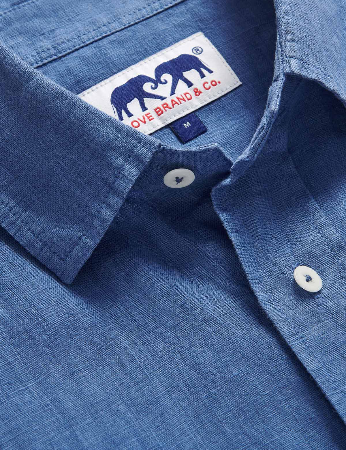 Detailed view of Men's Deep Blue Andros Linen Shirt. Denim blue linen shirt with double breasted pockets. Long-sleeved, button-up shirt.