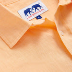 close-up view of the classic collar of Men's Orange Sorbet Abaco Linen Shirt. Long-sleeved button-up shirt made from 100% in orange. 