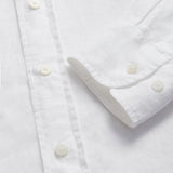 Close-up of Men's White Andros Linen Shirt cuffs. Long-sleeved, button-up white linen shirt. Double-breasted with a classic collar.