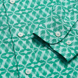 Men's Palm Eagle Abaco Linen Shirt close-up featuring tropical palm leaf and eagle pattern in green and white.
