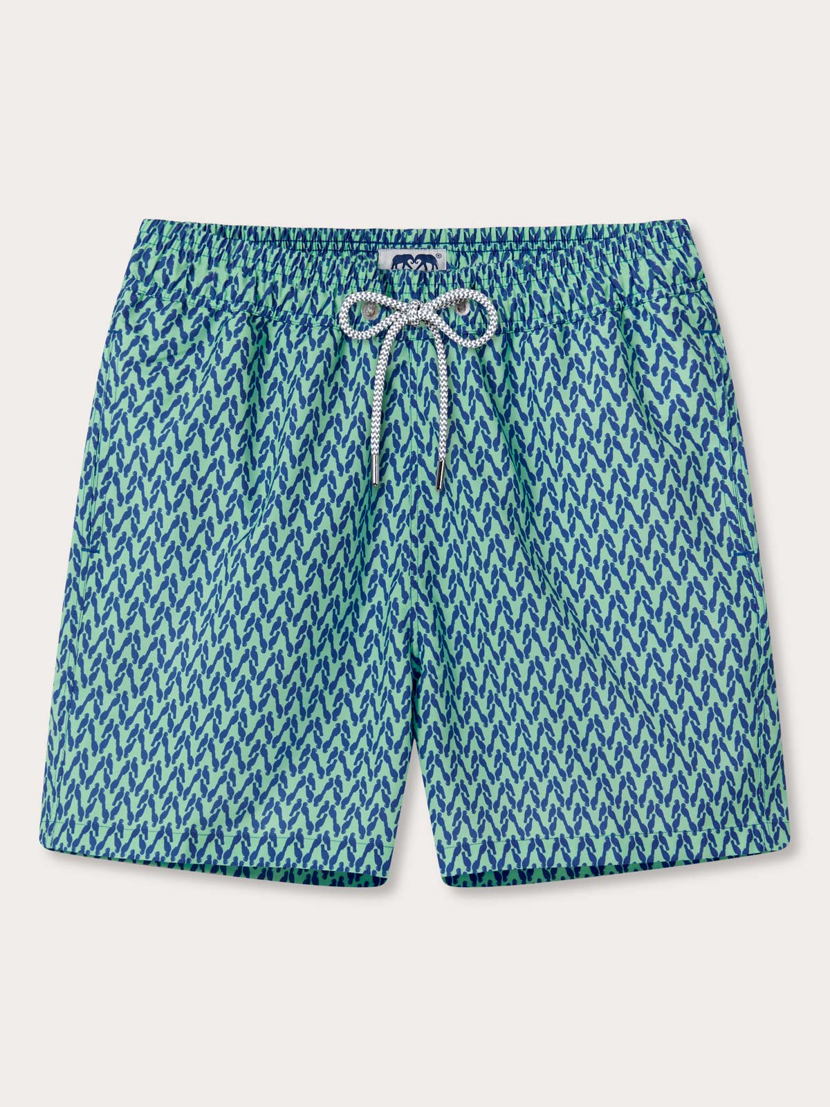 Front view of Men's Parrot Paradise Staniel Swim Shorts. Green swimming shorts with a blue parrot pattern with drawstring waist and pockets.