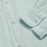 Close-up of Sea Air Abaco men's Linen Shirt in pastel hue showing buttons and sleeve details.