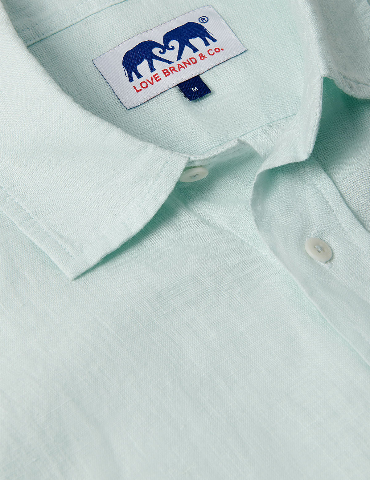 Close-up view of Sea Air Abaco men's Linen Shirt in pastel hue showing the collar and brand tag. Old money shirts made from 100% linen.