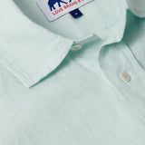 Close-up view of Sea Air Abaco men's Linen Shirt in pastel hue showing the collar and brand tag. Old money shirts made from 100% linen.