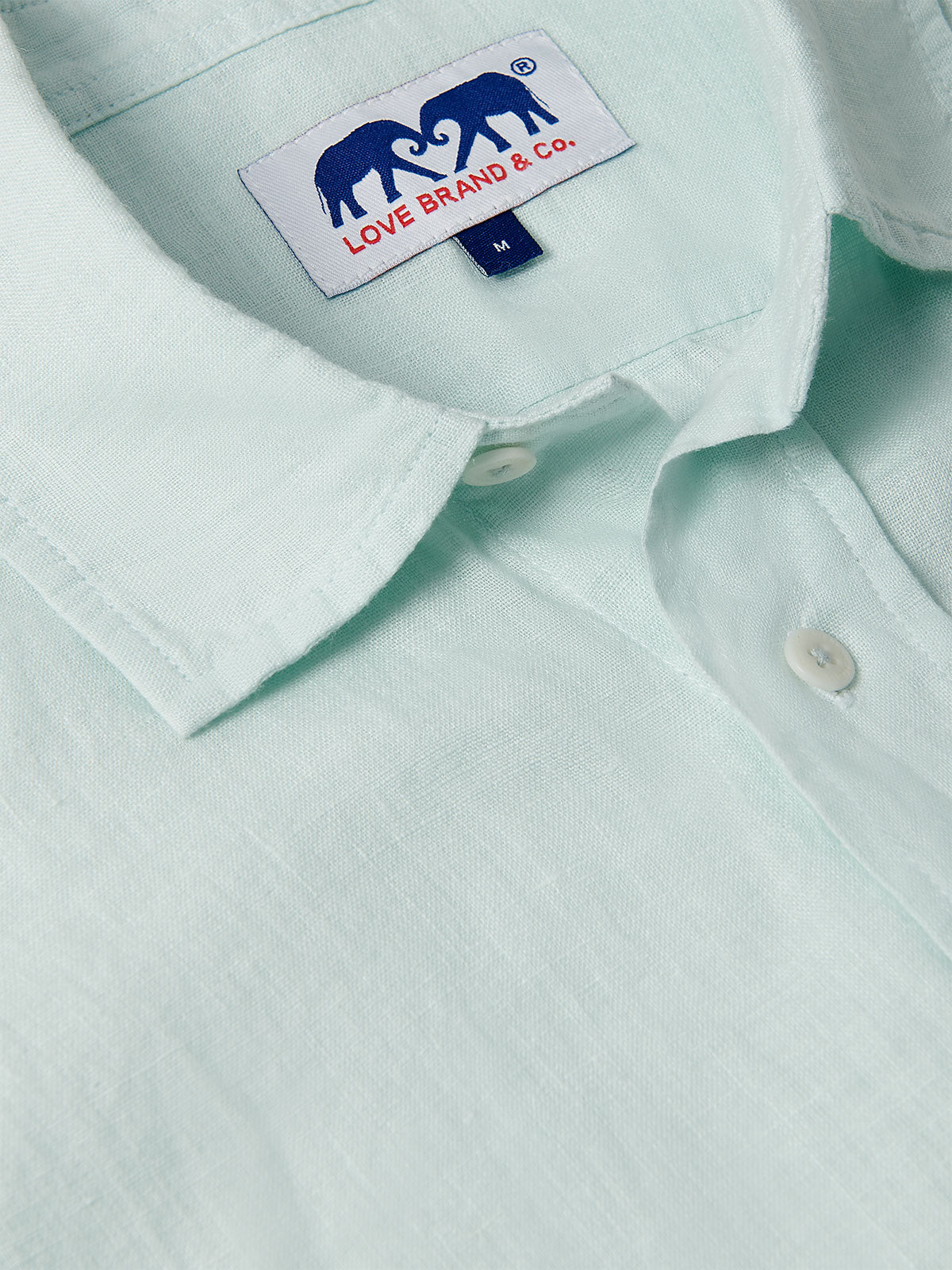 Close-up view of Sea Air Abaco men's Linen Shirt in pastel hue showing the collar and brand tag. Old money shirts made from 100% linen.