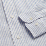 Close-up view of Men's Sky Lines Abaco Linen Shirt showing sky blue thin lines on white base with white buttons.