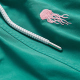 Palm Green Men's Smack Attack Embroidered Staniel Swim Shorts featuring a pink jellyfish motif and durable white drawstring.