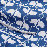 Staniel white heron mens swim shorts detail. This design features white herons on a dark blue background.