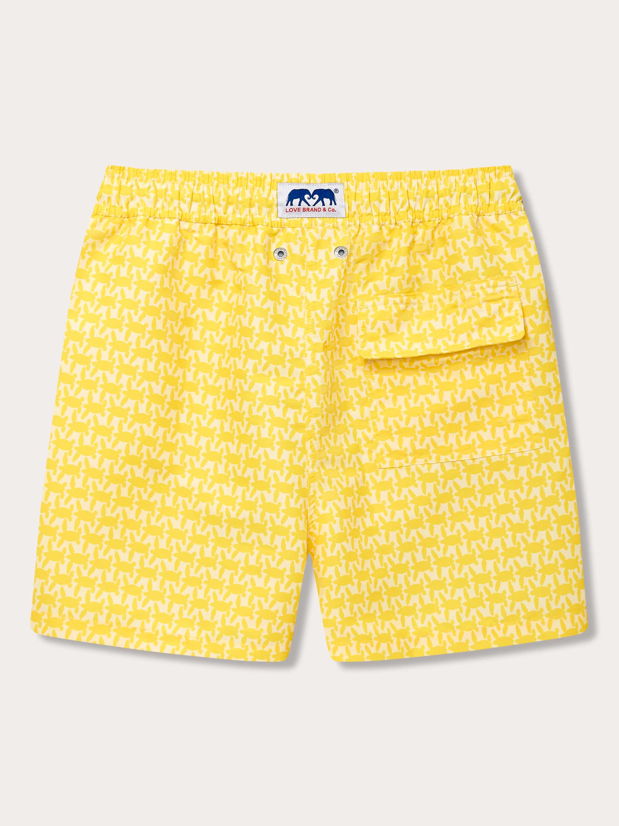 Yellow men's swim shorts with a patterned design inspired by endangered turtles. Patterned swim shorts featuring an elastic waistband and a front pocket.