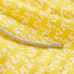 Close-up of Men's Turtle Light Staniel Swim Shorts in sunny yellow with a pattern of small turtles and a white adjustable drawstring.