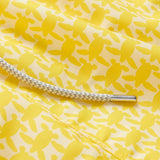 Close-up of Men's Turtle Light Staniel Swim Shorts in sunny yellow with a pattern of small turtles and a white adjustable drawstring.