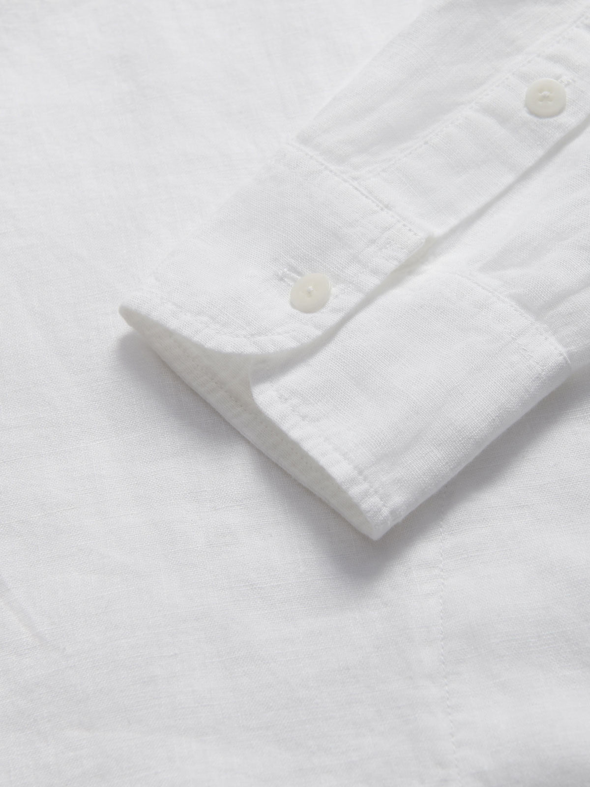 Detailed view of the cuffs of Men's White Windermere Linen Long Sleeve Hoodie. Long-sleeved half-button-up 100% linen hoodie. 2 front pockets with a drawstring hood.